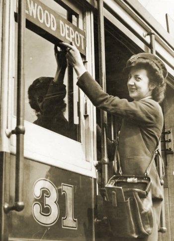 Conductress changing the destination sign on VR tram, 1943. Phototgraph State Library of Victoria.